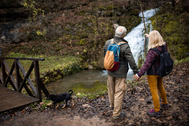 istock Mature couple by a waterfall 1496125720