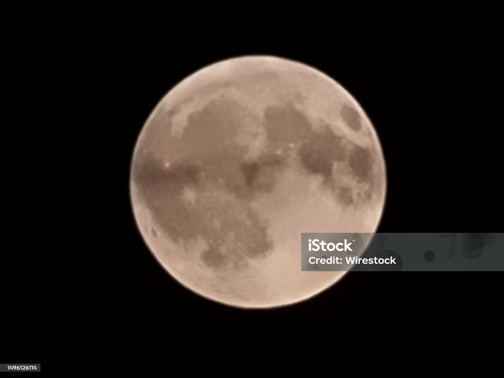 Clear night sky illuminated by a full moon A clear night sky illuminated by a full moon Color Image Stock Photo