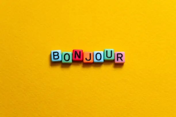 Bonjour - word concept on cubes, text, letters