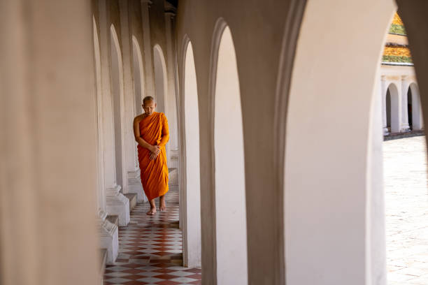 Monks walk in harmony and practice the dharma at Wat Phra Pathom Chedi. Nakhon Pathom Province, Thailand