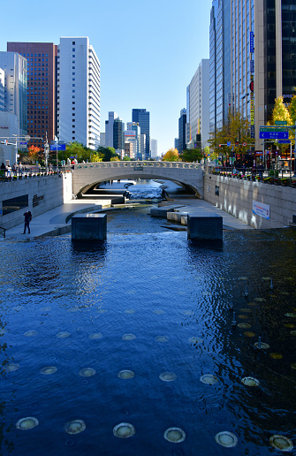 Seoul, South Korea: office towers and Mojeongyo Bridge on the west end of Cheonggyecheon Stream near Cheonggye Plaza and Gwanghwamun Square - Cheonggye Stream is an 11 km long stream flowing west to east through downtown - is was covered for decades but re-exposed in a large urban renewal project - Jongno.