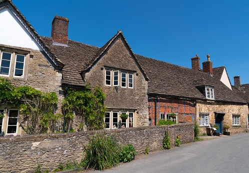 Old historic architecture of the houses and buildings in the historic tourist destination village of Lacock, Wiltshire, England, UK on Wednesday 24th May 2023