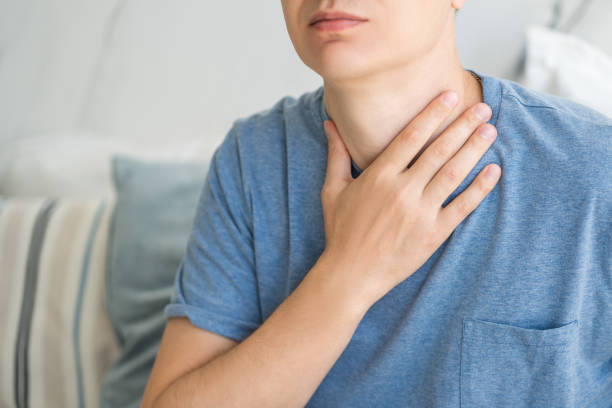 sore throat and cough, man with pain in neck at home - surprise color image gasping the human body imagens e fotografias de stock