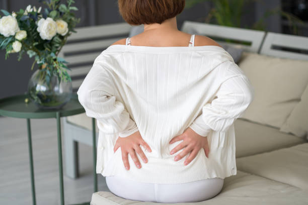 istock Back pain, kidney inflammation, woman suffering from backache at home 1496128100