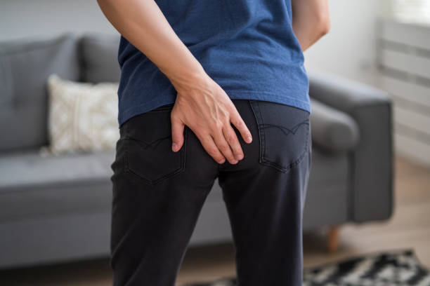 istock Hemorrhoidal pain, man suffering from hemorrhoids at home 1496128192