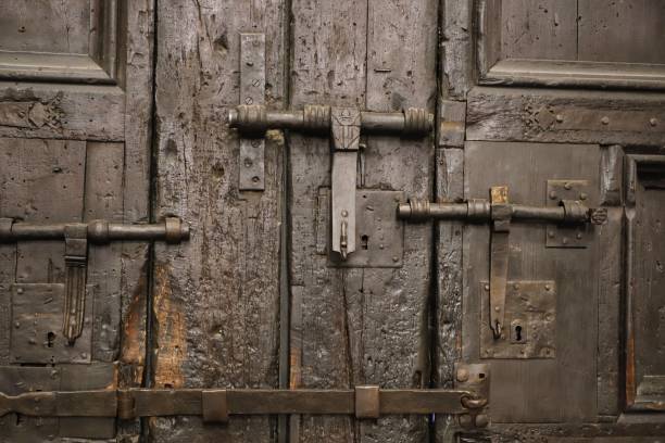 istock Aged, rusted metal doors with faded paint and multiple locks 1496128234