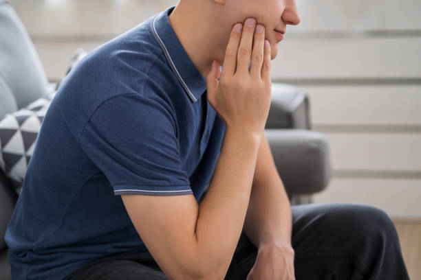 A man with toothache, periodontal disease in wisdom teeth A man with toothache, periodontal disease in wisdom teeth, health problems concept pain  remove stock pictures, royalty-free photos & images