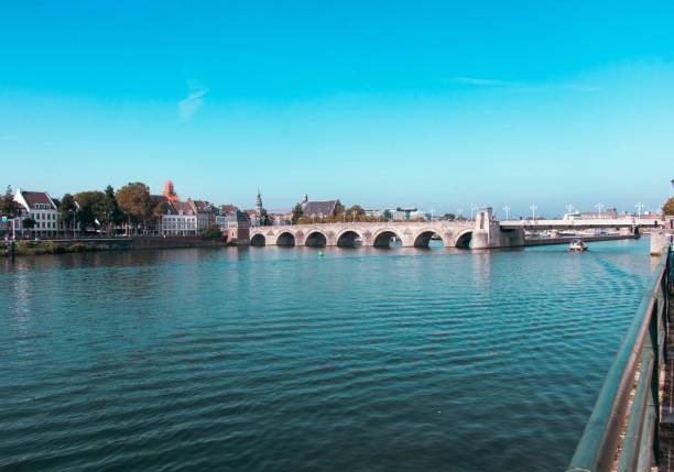 istock Arched bridge over the river with residential buildings lined on the sides 1496129364