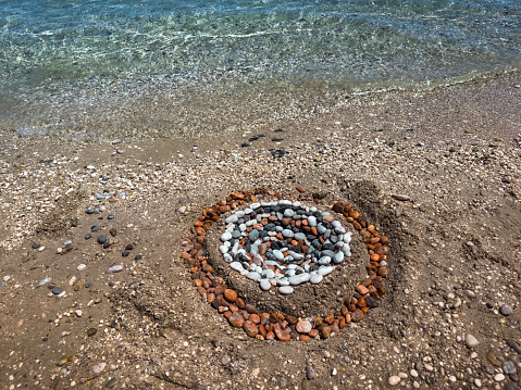 Beautiful mandala from pebbles in Baska beach (Krk, Croatia).