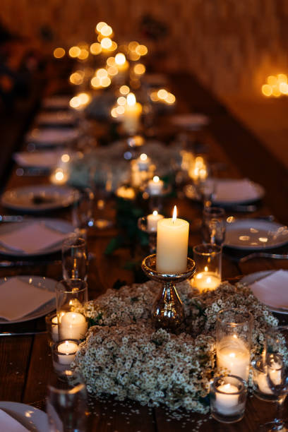 istock Festive wedding table setting with forgetmenot flowers and candles. Evening table decorations with quiet atmosphere created by plenty of candles 1496129652