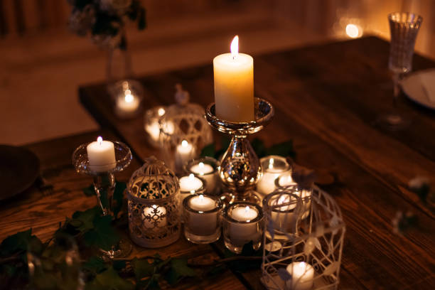 istock Candles in the flasks and cages set on table decorations on wooden background 1496129655