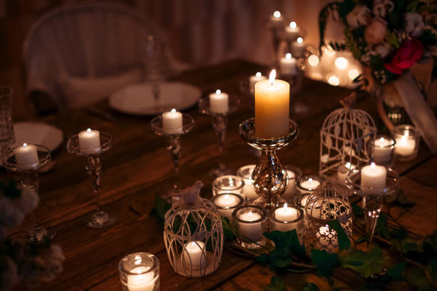 istock Candles in the flasks set on table decorations surrounding plates at cozy warm atmosphere 1496129660