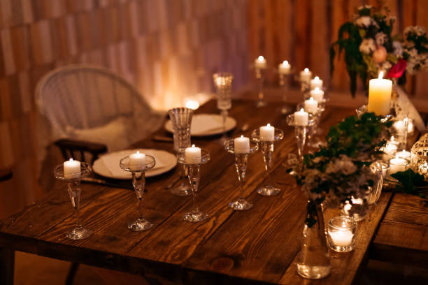 istock Candles in the flasks set on table decorations surrounding plates at cozy warm atmosphere 1496129670