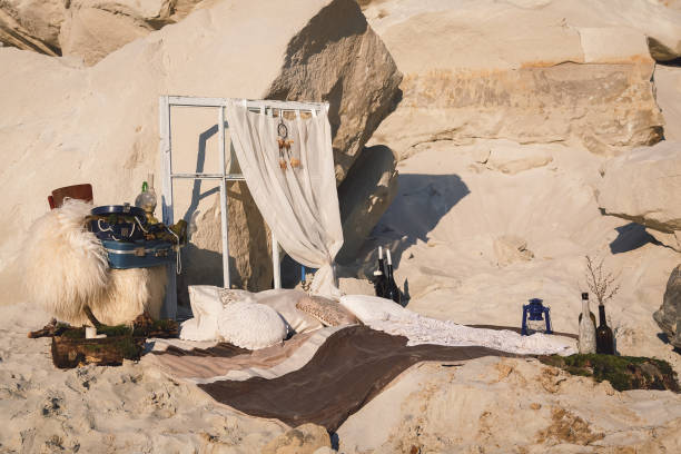 istock Boho decorations surrounded by sand. Pillows, dream-catchers and 1496129679