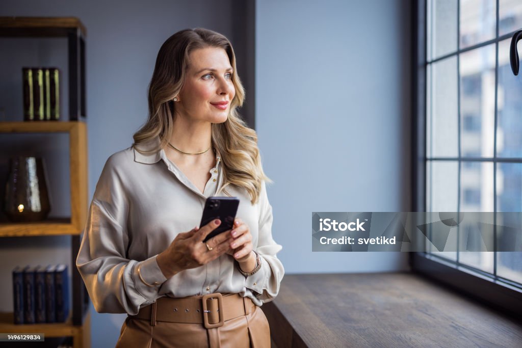 Women leader in her business Portrait of a confident mature businesswoman working in a modern office. Women Stock Photo