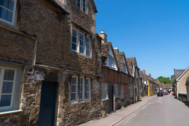 Photo of Lacock Wiltshire England UK quaint village street in tourist destination