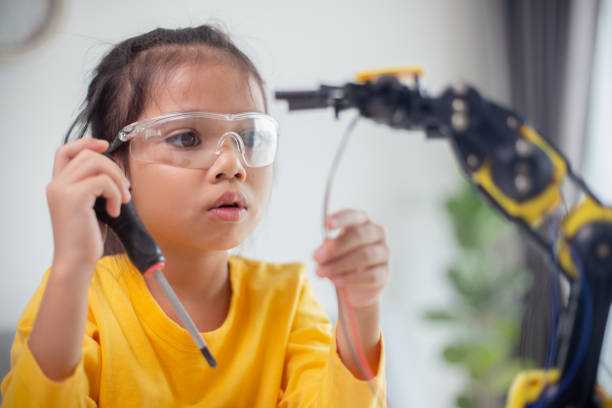 istock STEM education concept. Asian students learn at home by coding robot arms in STEM, mathematics engineering science technology computer code in robotics for kids' concepts. 1496130789