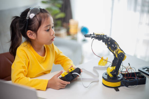 istock STEM education concept. Asian students learn at home by coding robot arms in STEM, mathematics engineering science technology computer code in robotics for kids' concepts. 1496130798