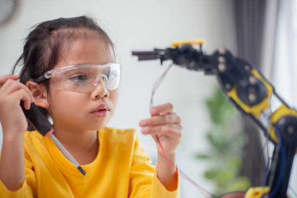istock STEM education concept. Asian students learn at home by coding robot arms in STEM, mathematics engineering science technology computer code in robotics for kids' concepts. 1496130799