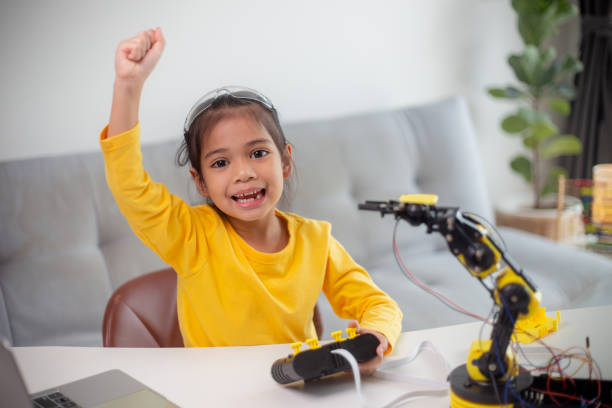 istock STEM education concept. Asian students learn at home by coding robot arms in STEM, mathematics engineering science technology computer code in robotics for kids' concepts. 1496130816