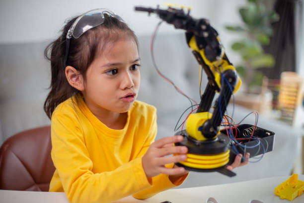 istock STEM education concept. Asian students learn at home by coding robot arms in STEM, mathematics engineering science technology computer code in robotics for kids' concepts. 1496130817