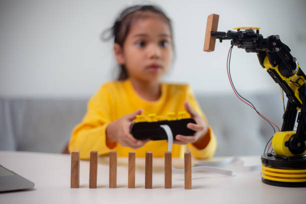 istock STEM education concept. Asian students learn at home by coding robot arms in STEM, mathematics engineering science technology computer code in robotics for kids' concepts. 1496130834
