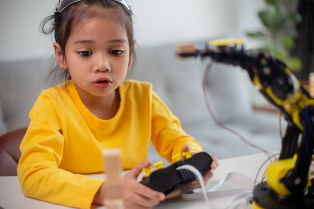 istock STEM education concept. Asian students learn at home by coding robot arms in STEM, mathematics engineering science technology computer code in robotics for kids' concepts. 1496130835