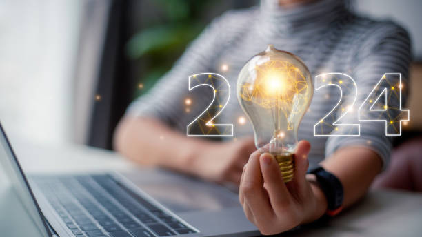 istock 2024 creative concept, women holding light bulb 2024 numbers, 2024 number for creative thinking idea for starting new business concept. 1496130891