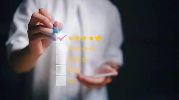 Photo of Women giving five yellow stars indicate the highest level of customer satisfaction and evaluation for a high-quality product and service on a futuristic virtual interface screen.