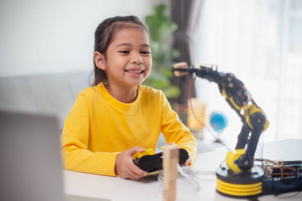 istock STEM education concept. Asian students learn at home by coding robot arms in STEM, mathematics engineering science technology computer code in robotics for kids' concepts. 1496130933