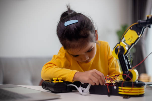 istock STEM education concept. Asian students learn at home by coding robot arms in STEM, mathematics engineering science technology computer code in robotics for kids' concepts. 1496130962