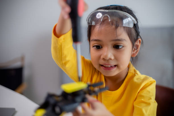 istock STEM education concept. Asian students learn at home by coding robot arms in STEM, mathematics engineering science technology computer code in robotics for kids' concepts. 1496130965