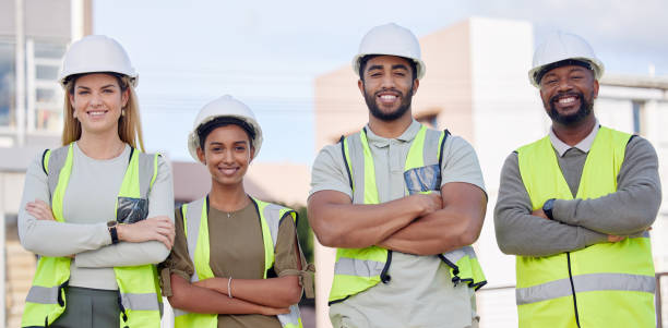 istock Architecture, construction team and diversity in portrait, contractor group smile with work at building site. Architect, engineer and people with arms crossed, solidarity and trust in collaboration 1496131191