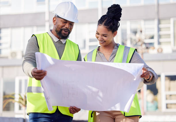 istock Contractor, engineering blueprint and black people with teamwork, project manager planning and collaboration. Architecture, outdoor construction worker and floor plan for urban development in city 1496131198