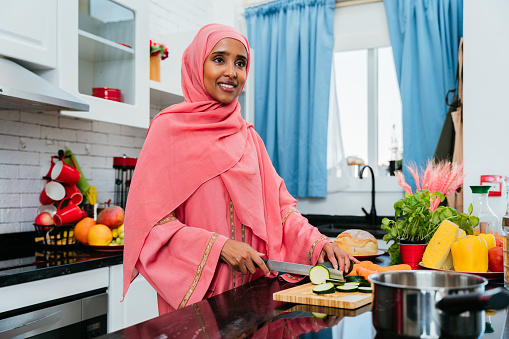 Happy and beautiful  middle eastern woman wearing traditional arab clothing at home