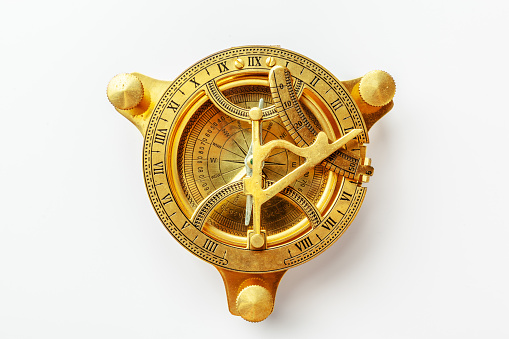 Antique golden compass isolated on white background