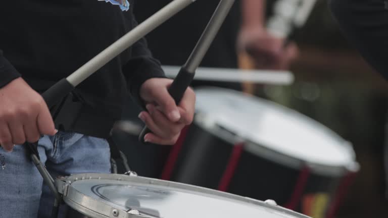 People hitting the drums on the street