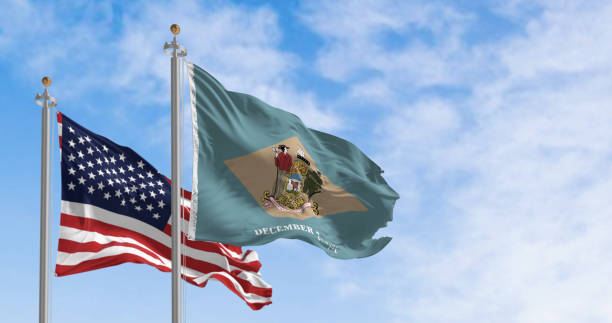 istock Delaware and United States flags waving on a clear day 1496134782