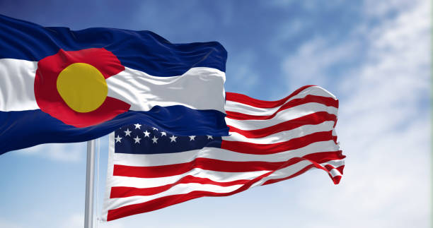 istock Colorado and US flags waving in the wind on a clear day 1496134882