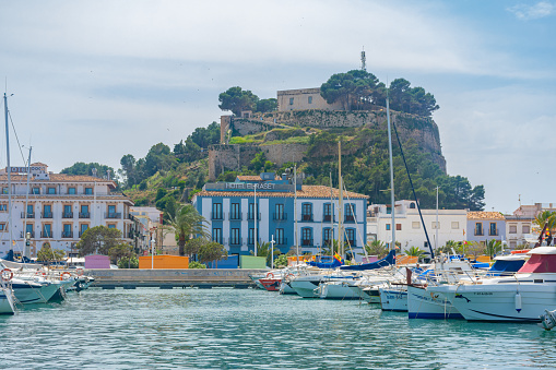 Denia, Alicante, Spain. May 22, 2022 - Raset hotel, in front of the marina, in the old neighbourhood of the town. Denia castle at background