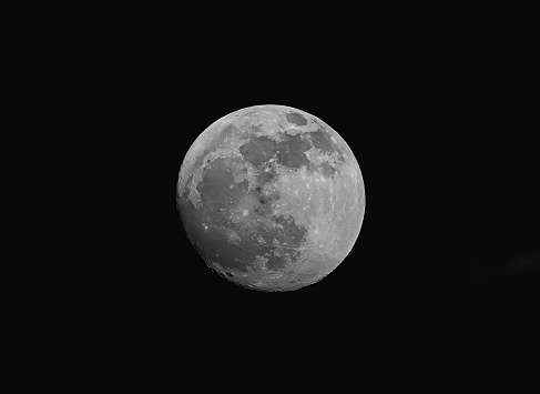 A full moon is illuminated in night sky