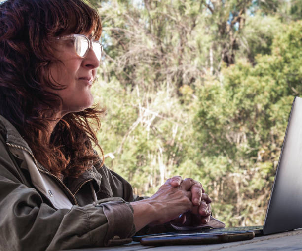 istock woman in profile with laptop 1496139170