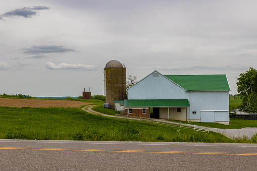 Agricultural landscape with fields, silo and barn in Amish Country in rural Ohio, USA
