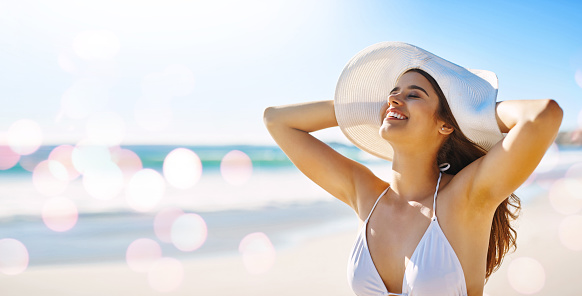Travel, beach and woman on summer, vacation and holiday against bokeh, water and nature background. Happy, freedom and girl relax at the ocean, fun and smile while enjoying freedom, sun and joy