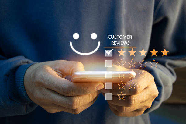 istock close up Man hand using smartphone with popup five star icon for feedback review satisfaction service, Customer service experience and business satisfaction survey. 1496143015