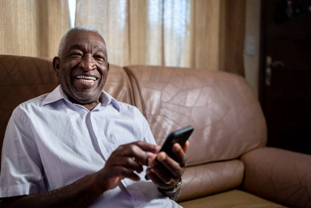 istock Portrait of a senior man using smartphone at home 1496145030