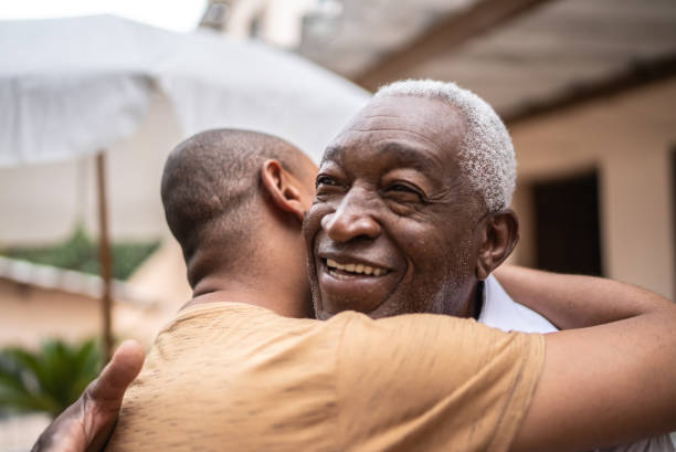 istock Father and son embracing in the backyard at home 1496145442