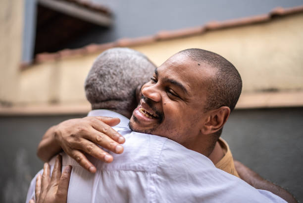istock Father and son embracing in the backyard at home 1496145446