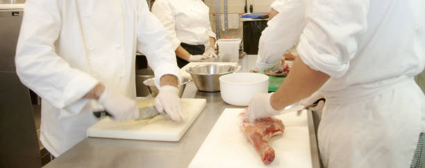 istock The chef debones and cleans raw meat on a cutting board before cooking. 1496149157