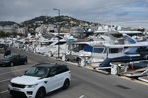 Docked Recreational Boat At Cannes Marina In French Riviera France Europe, Mediterranean Sea, Tree, Sky, Land Vehicle, Building Exterior, Mountain, People Scene During Springtime
